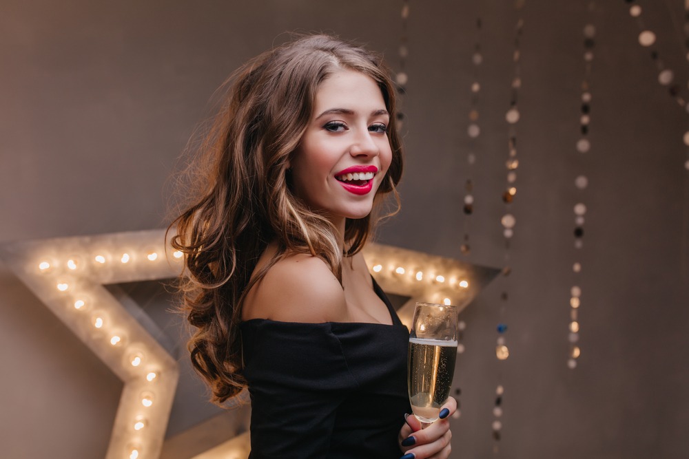A person holding a glass of champagne
